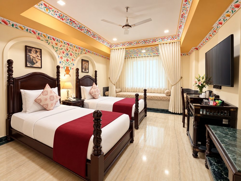 Twin bed room with heritage-style decor at Fort Chandragupt Hotel Jaipur